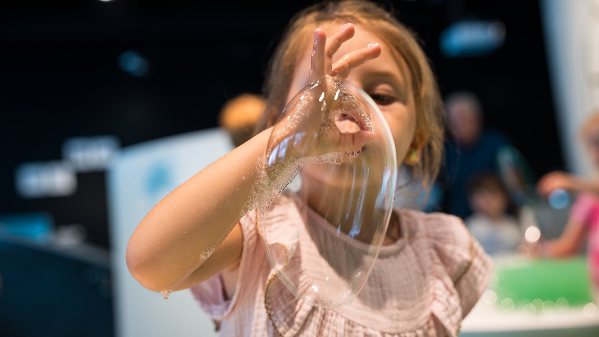 Kid blowing soap bubbles at Experimentarium